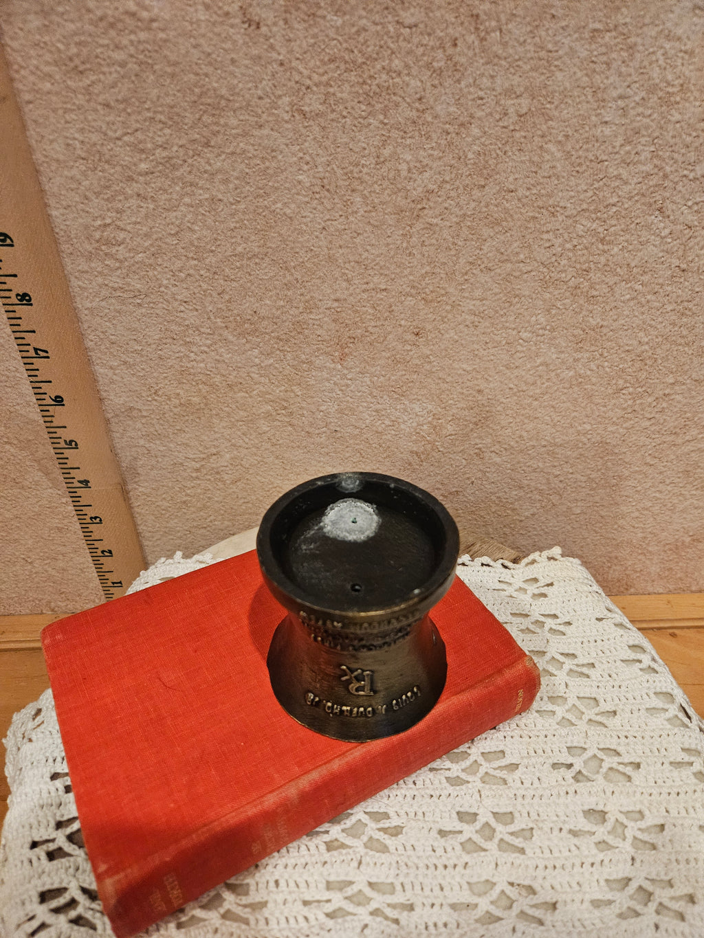 A vintage bronze pharmacy mortar and pestle, a symbol of the pharmacy profession, featuring intricate designs and historical inscriptions.