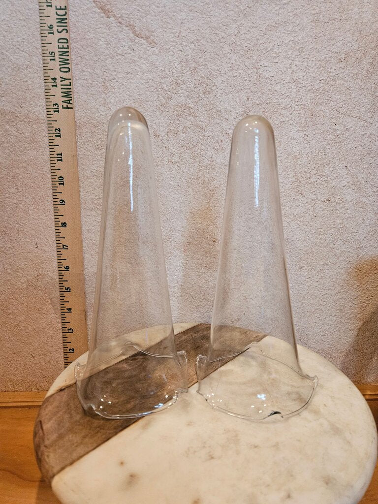 Set of two clear glass cone weights designed for stabilizing flower arrangements. Ideal for home decoration or event styling.