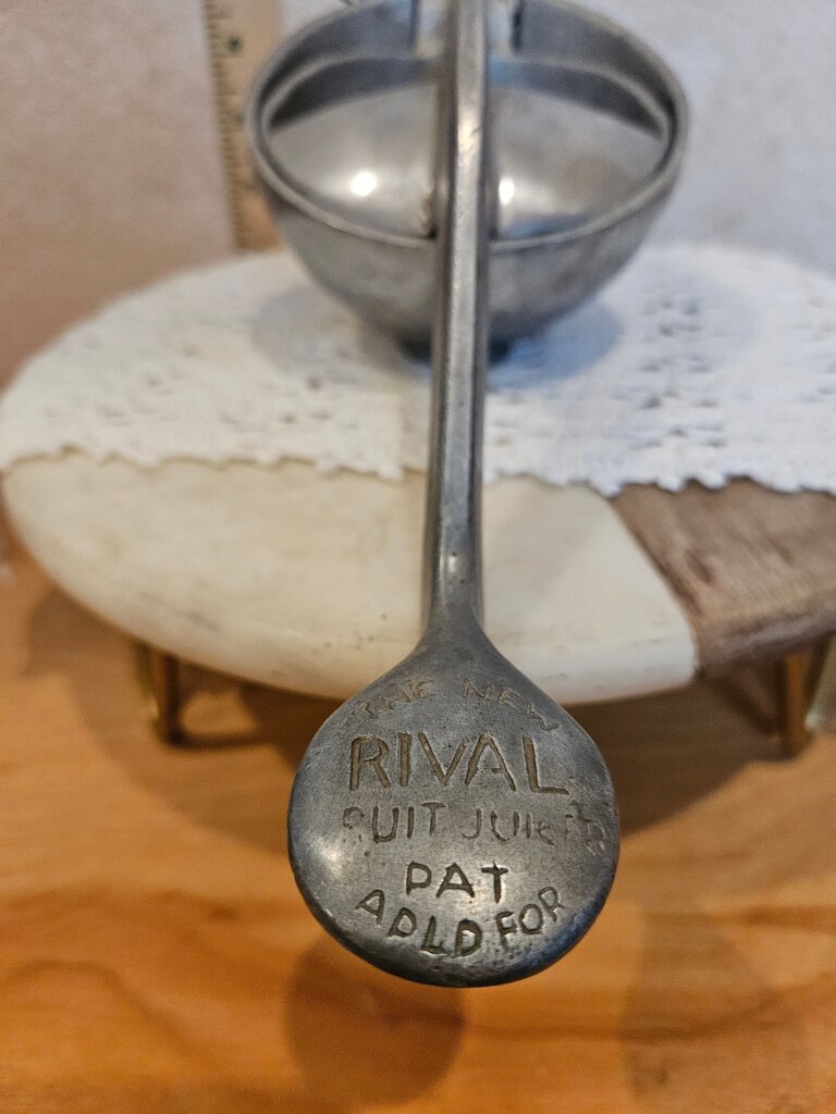 Vintage Metal Rival Fruit Tabletop Juicer on a riser, removeable base