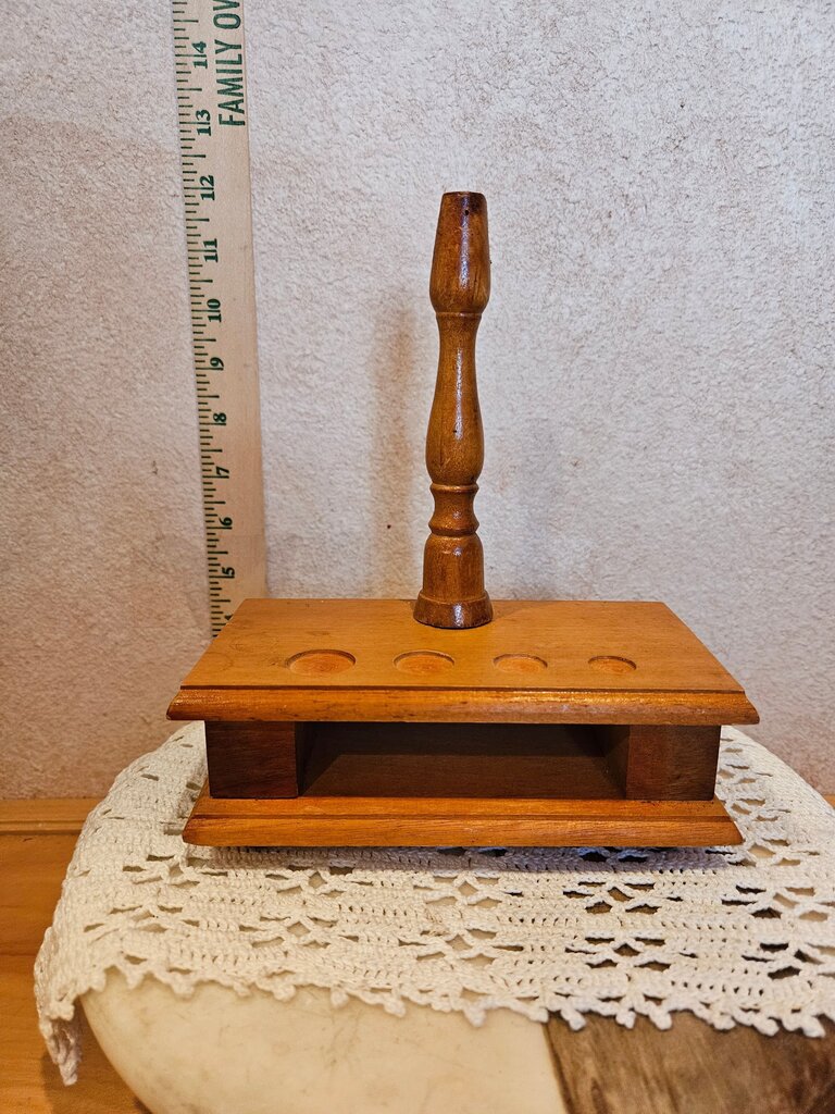 A charming used wooden candle holder featuring a classic design with spaces for four candles. Perfect for adding a rustic touch to your home decor.