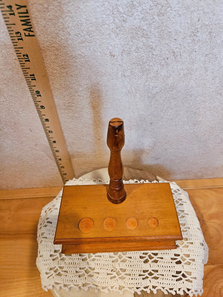 A charming used wooden candle holder featuring a classic design with spaces for four candles. Perfect for adding a rustic touch to your home decor.