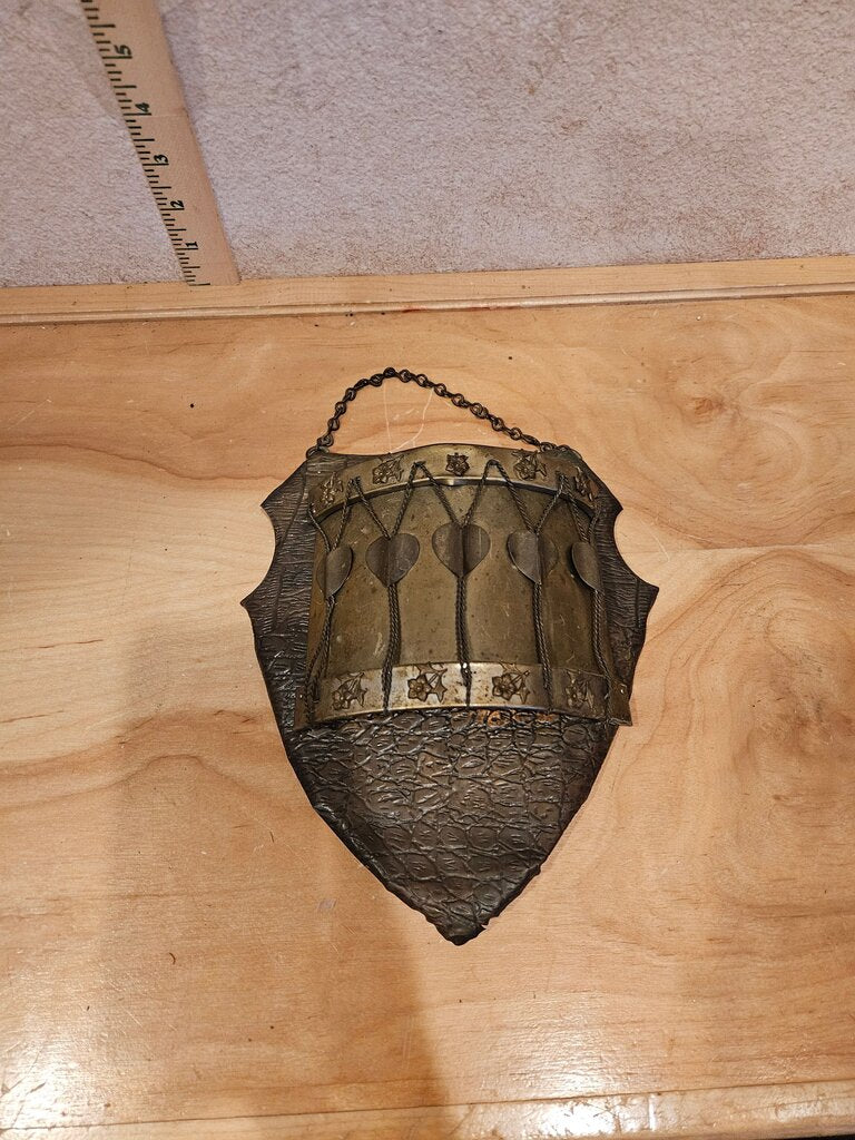 A unique vintage piece resembling a medieval shield wall pocket w floral and heart motifs