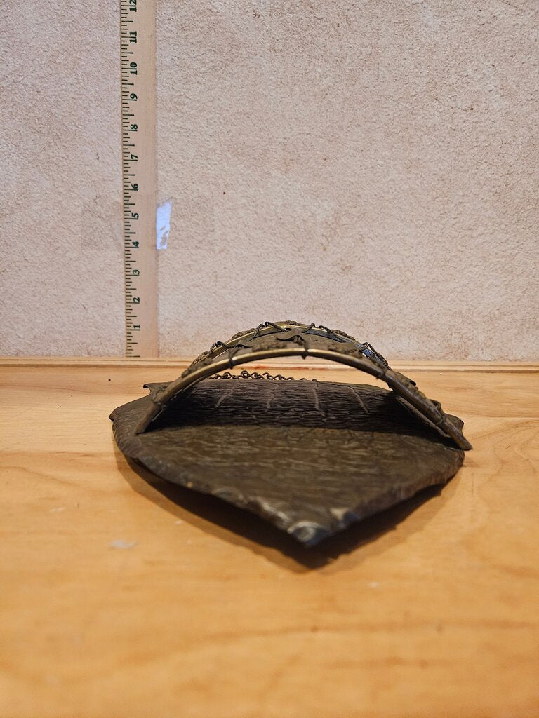 A unique vintage piece resembling a medieval shield wall pocket w floral and heart motifs