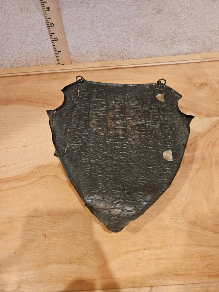 A unique vintage piece resembling a medieval shield wall pocket w floral and heart motifs