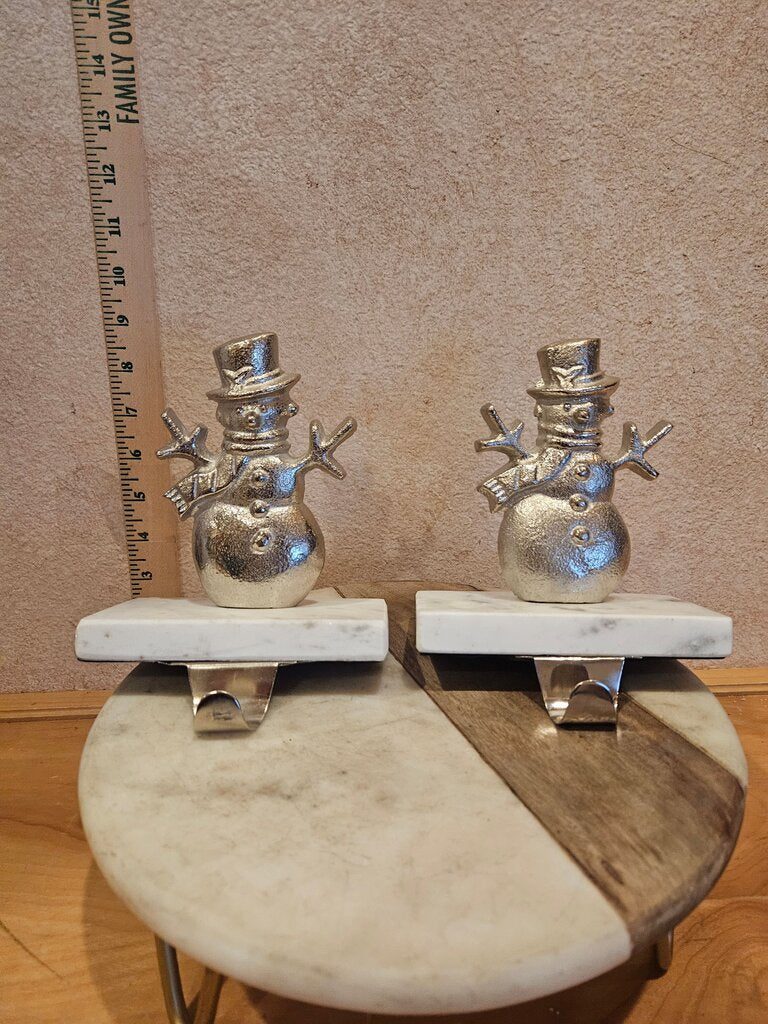 Two Silver Colored Snowmen On White Marble Bases Stocking Hangers mantel Holiday Christmas Decor